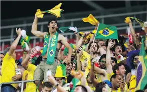  ?? VICTOR R. CAIVANO / THE ASSOCIATED PRESS ?? Brazil’s supporters celebrate the end of the group stage at the World Cup. “We don’t live off of expectatio­ns,” Brazilian coach Titi said post-game. “We live off reality.”