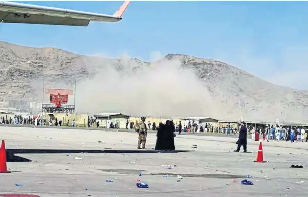  ??  ?? AFTERMATH: Smoke rises near the scene of one of the terrorist explosions that is believed to have killed at least 13 people at Kabul airport.