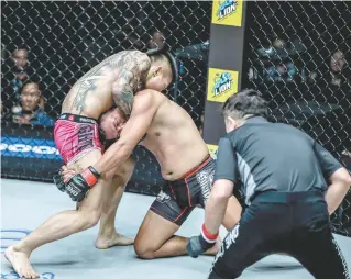  ??  ?? Li Kai Wen applies a guillotine choke on Roel Rosauro during their match in ONE: Quest for Gold at the Thuwunna Indoor Stadium in Yangon, Myanmar on Friday.