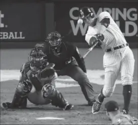  ?? FRANK FRANKLIN II, THE ASSOCIATED PRESS ?? Yankees’ Aaron Judge hits a home run during the seventh inning of Game 4 of baseball’s American League Championsh­ip Series against the Houston Astros on Tuesday night in New York. The Yankees won, 6-4, to even the best-of-seven series at 2-2.