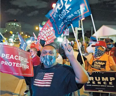  ?? WILFREDO LEE/AP ?? Supporters of President Donald Trump chant and wave flags during Election Night, in the Little Havana neighborho­od of Miami.