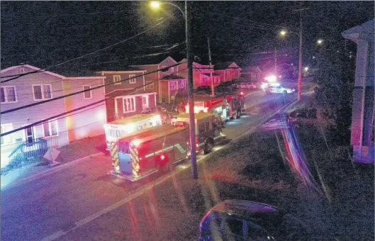  ?? CHRIS QUIGLEY/THE WESTERN STAR ?? Emergency personnel deal with a house fire on Country Road in Corner Brook early Tuesday morning.