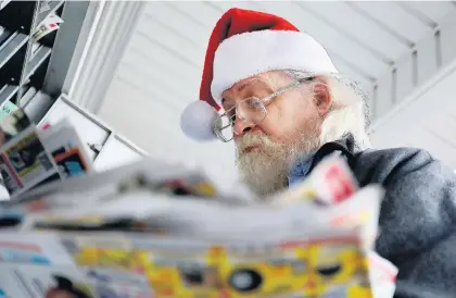  ?? STEVE EARLEY/STAFF ?? Mark Gronski, a mailman for over 30 years, delivers mail, and sometimes a Christmas miracle, as he works his route in Norfolk on Christmas Eve.