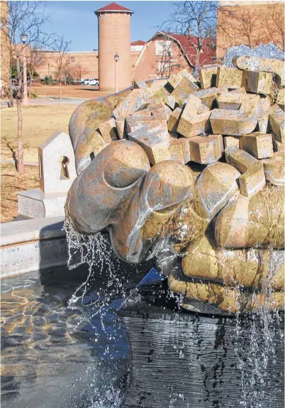  ??  ?? Larry Kirkland’s granite “Headwaters” has been a student favorite on the campus of Texas Tech University in Lubbock. The hands hold letters of the alphabet.