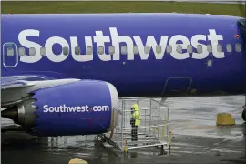  ?? TED S. WARREN — THE ASSOCIATED PRESS ?? A worker inspects an engine on a Boeing 737Max 8built for Southwest Airlines at Renton Municipal Airport in Renton, Wash.