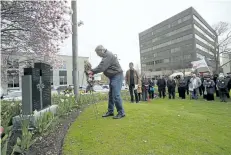  ?? JULIE JOCSAK/POSTMEDIA NETWORK ?? Peter Barber lays a wreath during the National Day of Mourning ceremony in St. Catharines last year.