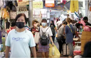  ?? Photo by Apichart Jinakul ?? Face masks are one of the main forms of protection from Covid-19 among people from all walks of life.