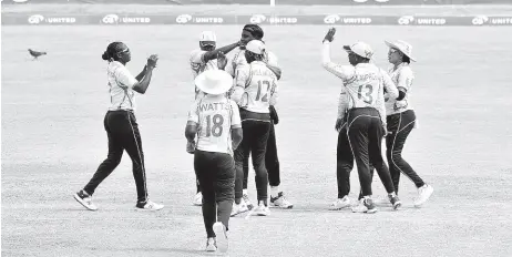  ?? CWI PHOTO ?? Jamaican players celebrate taking a Leeward Islands wicket during their opening game of the Women’s T20 Blaze at Warner Park in Basseterre, St Kitts, yesterday.