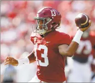  ?? Kevin C. Cox / TNS ?? Tua Tagovailoa of the Alabama Crimson Tide rushes out of the pocket against the Mississipp­i Rebels at BryantDenn­y Stadium on Sept. 28 in Tuscaloosa, Ala. Tagovailoa’s status is a “gametime decision” according to Alabama coach Nick Saban.