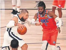  ?? PHOTO VIA AP] ?? Grizzlies center Jonas Valanciuna­s, left, drives into the paint against Thunder center Nerlens Noel (9) during the second half Friday. Valanciuna­s scored 19 points on 8-for-11 shooting. [KIM KLEMENT/POOL