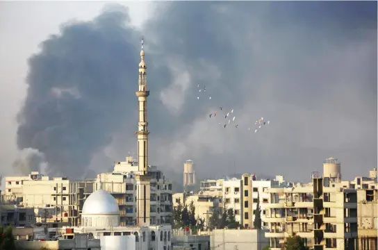  ??  ?? Smoke rises following an airstrike on the opposition-held besieged town of Harasta, in the Eastern Ghouta region on the outskirts of Damascus, on Tuesday. (AFP)