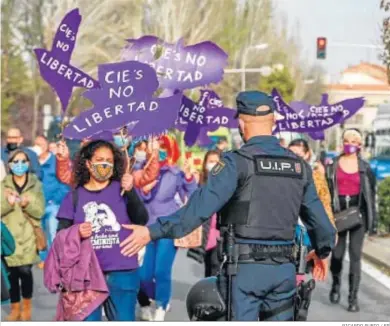  ?? RICARDO RUBIO / EP ?? Un agente de la Policía Nacional guía ayer una marcha y batukada feminista en el barrio de Lucero, en Madrid.