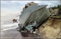  ?? The Associated Press ?? BEACHFRONT: A house slides into the Atlantic Ocean Monday in the aftermath of Hurricane Irma in Ponte Vedra Beach, Fla.