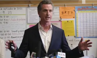  ?? Ap ?? STILL HERE: California Gov. Gavin Newsom speaks to the press after visiting with students in Oakland, Calif. Newsom beat back a recall effort on Tuesday.