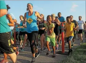  ?? GENE WALSH — DIGITAL FIRST MEDIA ?? Runners of all ages cross the starting line during the Solidarity Run at the Norristown Farm Park Wednesday. The 3-mile run, which also included a 1-mile walk, supported the Montgomery County Victim Services Center and was organized in reaction to a...