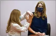  ?? JESSICA HILL — THE ASSOCIATED PRESS ?? Granby kindergart­en school teacher Christina Kibby receives the Johnson & Johnson COVID-19 vaccine by pharmacist Madeline Acquilano, left, at Hartford Hospital in Hartford, Conn., on Wednesday.