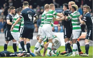  ??  ?? Scott Brown, centre, picks himself up after sparking a late melee with the challenge on Liam Boyce that earned him a red card.