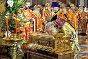  ?? THE ASSOCIATED PRESS ?? Russian Orthodox Patriarch Kirill on Sunday kisses a container of Saint Nicholas relics in the Christ the Savior Cathedral in Moscow, Russia.
