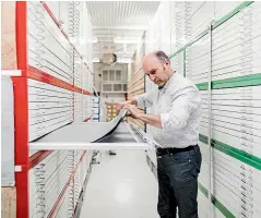  ??  ?? Adrian Humphris, team leader for city archives, checks some of the material in the collection.