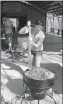  ??  ?? Brandi Newton stirs a 20-gallon pot of jambalaya April 9 at the Benton County Quail Barn in Bentonvill­e.