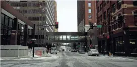  ?? MARGARET KISPERT/THE REGISTER ?? A person avoids the cold and walks through the skyline on 7th Street and Locust Street in Des Moines in December 2022.