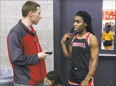  ?? Pat Eaton-Robb / Associated Press ?? Cromwell High School track coach Brian Calhoun, left, speaks to transgende­r athlete Andraya Yearwood during a break at a meet at Hillhouse High School in New Haven in February. Three Connecticu­t girls who participat­e on high school track teams have filed a federal discrimina­tion complaint against a statewide policy on transgende­r athletes, saying it has cost them top finishes in competitio­ns and possibly college scholarshi­ps.