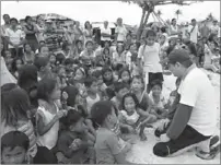  ??  ?? ICCP Group Foundation Inc. president Ricky I. Osmond (right) talks to children in the typhoon-affected areas.