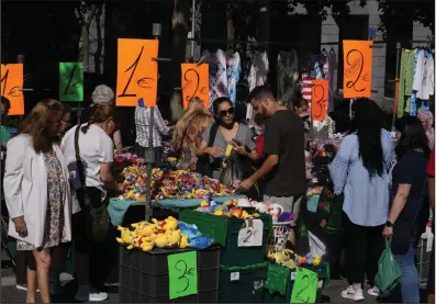  ?? (AP) ?? Goods for prices between one and three euros are offered in a street market in Madrid in June.