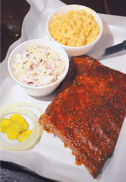  ?? ADOLPHE PIERRE-LOUIS/JOURNAL ?? The ribs with coleslaw with macaroni and cheese from Marley’s Barbeque in Los Ranchos de Albuquerqu­e.