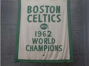  ?? NANCY LANE / HERALD STAFF ?? ‘OUT OF MOTHBALLS’: Historic Celtics banners, like this one from 1962, show signs of wear from over the years.