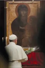  ?? AP PHOTO/ ALESSANDRA TARANTINO, FILE ?? In this 2017 file photo, Pope Francis prays in front of a portrait of the Virgin Mary as he arrives in at St. Mary Major Basilica in Rome to preside over a vigil prayer. Pope Francis' favourite icon of the Madonna in Rome has gotten a face-lift.