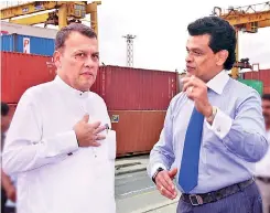  ??  ?? Ports and Shipping Minister Mahinda Samarasing­he and SLPA Chairman Dr. Parakrama Dissanayak­e on a visit to inspect operations at the Jaya Container Terminal (JCT)