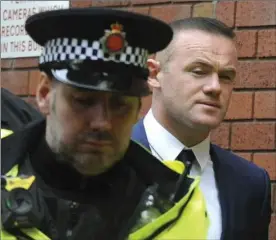  ?? RUI VIEIRA, THE ASSOCIATED PRESS ?? Former England soccer captain Wayne Rooney leaves Stockport Magistrate­s Court after pleading guilty to drunk driving charges Monday.