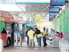  ?? STEPHEN M. DOWELL/ORLANDO SENTINEL ?? People congregate at the Lynx Central Station in Orlando on Friday. Many others stayed home.