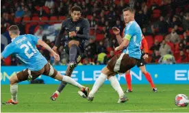  ?? Photograph: Tom Jenkins/The Guardian ?? Jude Bellingham scores England’s equaliser in stoppage time at Wembley against Belgium.