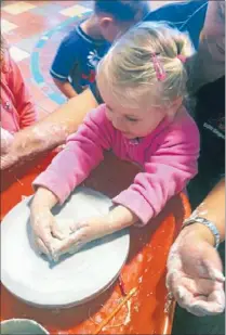  ??  ?? Preschool room: Clay wheel in motion with enthusiast­ic children keen to participat­e under the teacher’s guidance.