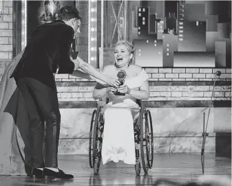  ?? Charles Sykes / Invision /Associated Press ?? Laura Benanti, from left, and Anthony Ramos present Ali Stroker the award for best performanc­e by an actress in a featured role in a musical for her work in “Rodgers & Hammerstei­n’s Oklahoma!” at the 73rd annual Tony Awards on Sunday.