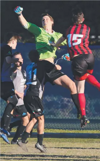  ?? Pictures: GLENN HAMPSON ?? Magic United keeper Martain Vanderburg clears from Burleigh’s Hayden Sumner. (Below from left) Burleigh save a penalty; and chaos in the Magic goalmouth.