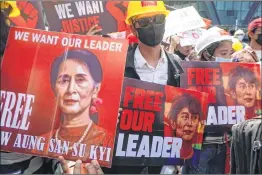  ??  ?? Protesters hold signs calling for the release of detained Myanmar civilian leader Aung San Suu Kyi during a demonstrat­ion against the military coup in Yangon on Sunday.