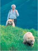  ?? THE CANADIAN PRESS ?? Charlie Russell walks in the Alberta foothills. The Alberta naturalist died Monday. He was 76.