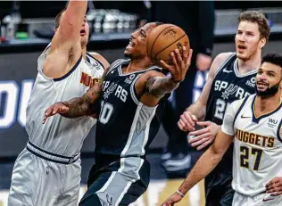  ?? William Luther / Staff photograph­er ?? DeMar DeRozan drives to the hoop against Nuggets center Nikola Jokic. DeRozan on Friday night became the only Spur besides Tony Parker with multiple 30-point, 10-assist games.