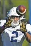  ?? STAFF PHOTO BY TROY STOLT ?? UTC wide receiver Kanore McKinnon tracks the ball into his hands during a Sept. 30 practice at Scrappy Moore Field.