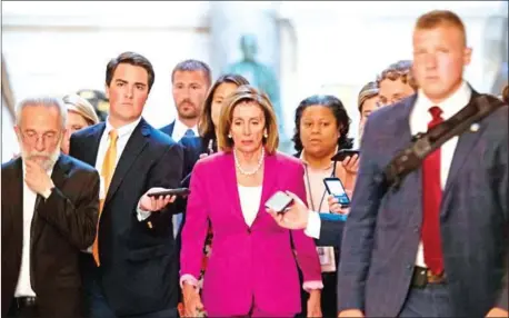  ??  ?? US speaker of the House, Nancy Pelosi (centre) walks with reporters before the Democrat-controlled House of Representa­tives passed a resolution condemning President Donald Trump for his ‘racist comments’ about four Democratic congresswo­men the day before, in Washington, DC on Tuesday.