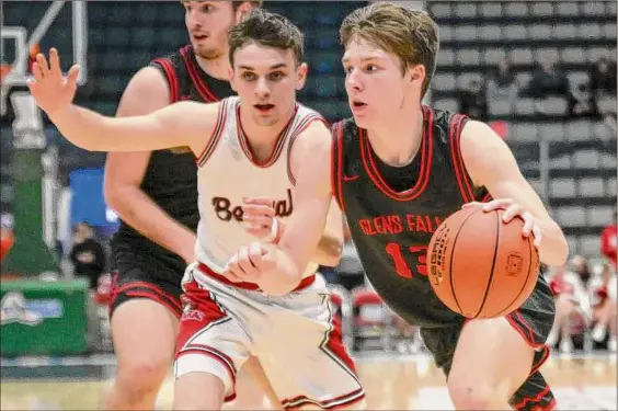  ?? Jim Franco / Times Union ?? Glens Falls sophomore Kellen Driscoll drives to the basket with Tamarac senior Mikey D’agostino in pursuit during their Class B semifinal matchup on Wednesday at Cool Insuring Arena in Glens Falls. Driscoll had 26 points, six rebounds and three steals as the Indians defeated the Bengals.