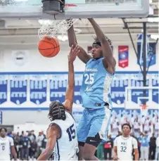  ?? SCOTT ASH / MILWAUKEE JOURNAL SENTINEL ?? St. Thomas More's Sekou Konneh (25) dunks on Milwaukee Academy of Science's Jamarion Batemon (15) during the WIAA Division 3 sectional semifinal at Oak Creek on Thursday.