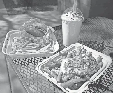  ?? ANDY BLYE ?? A cheeseburg­er meal, pumpkin pie milkshake and funnel cake fries with whipped cream and Fruity Pebbles from Nurdberger in Gilbert.
