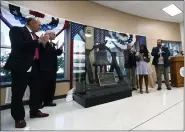  ?? BILL UHRICH — MEDIANEWS GROUP ?? Commission­ers Michael S. Rivera, Kevin S. Barnhardt and Christian Y. Leinbach with Jaclyn Victor from America 250PA and the Berks History Center’s Executive Director Ben Neely unveil the Berks Liberty Bell during a ceremony Thursday at the Berks County Services Center that kicks off the display of the bell ahead of the nation’s 250th birthday in 2026.