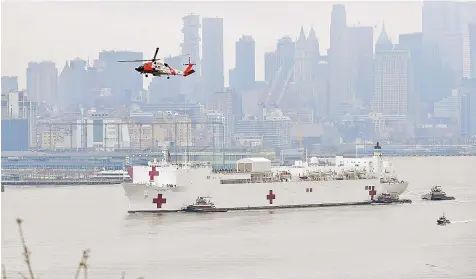  ?? — AFP photo ?? The USNS Comfort medical ship moves up the Hudson River as it arrives in New York as seen from Weehawken, New Jersey.