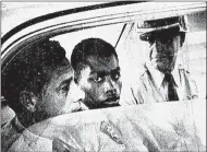  ?? JOHN BOSS — VIA THE ASSOCIATED PRESS ?? Henry Montgomery, flanked by two deputies, awaits the verdict in February 1964in his trial for the murder of Deputy Sheriff Charles Hurt in Louisiana. On Wednesday, a Louisiana parole board voted to grant Montgomery parole.