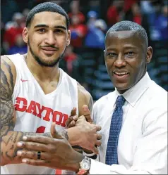  ?? AARON DOSTER / AP ?? Dayton’s Obi Toppin celebrates his 1,000th career point with coach Anthony Grant after a Feb. 22 game against Duquesne. Toppin was named the AP player of the year Tuesday and Grant is AP coach of the year.